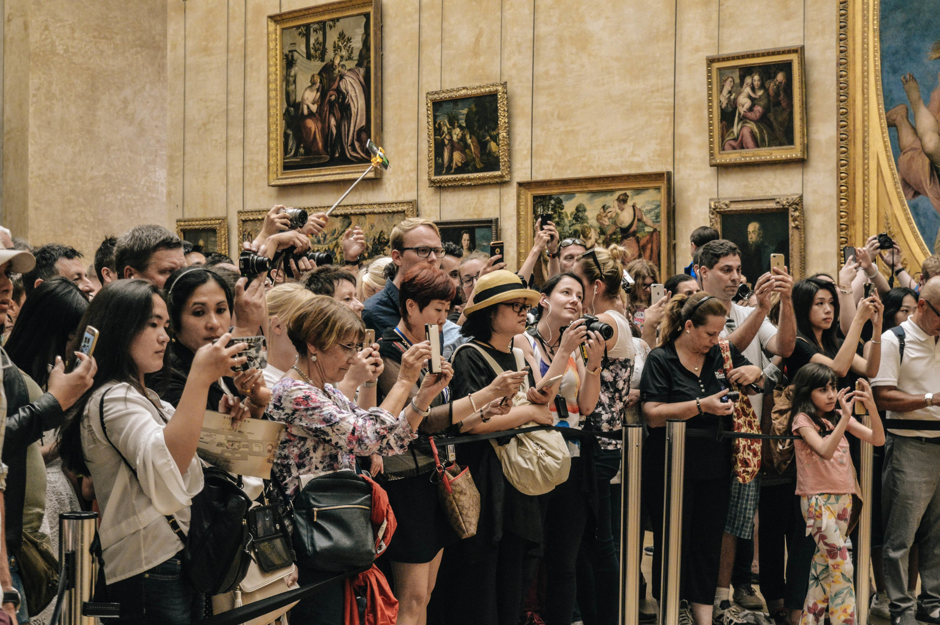 A large group of people taking pictures at a museum