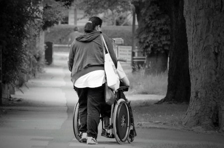 A wheelchair user and his carer