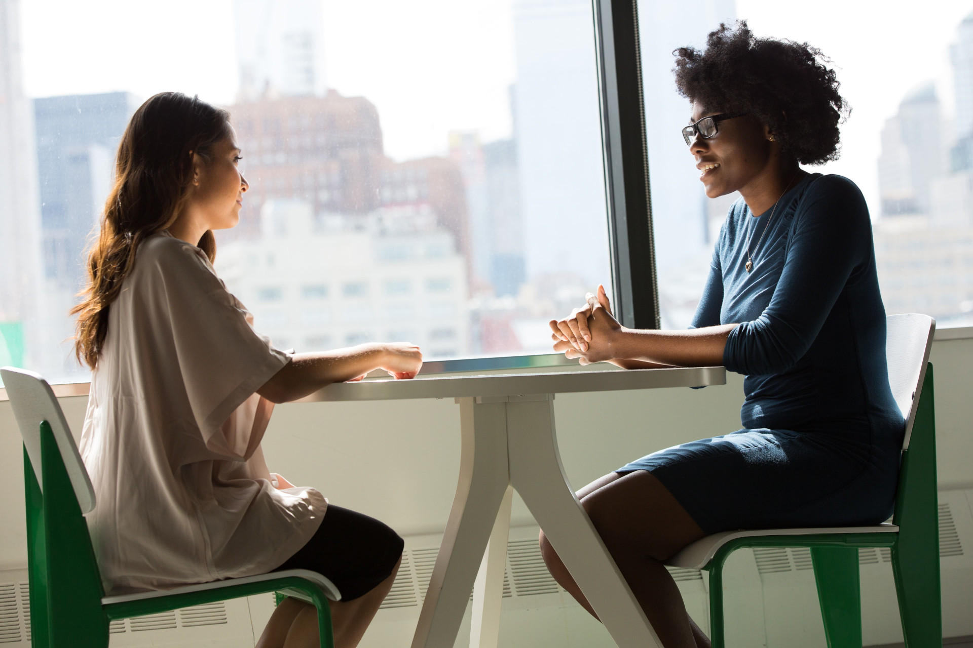 Two people sitting face to face and chatting