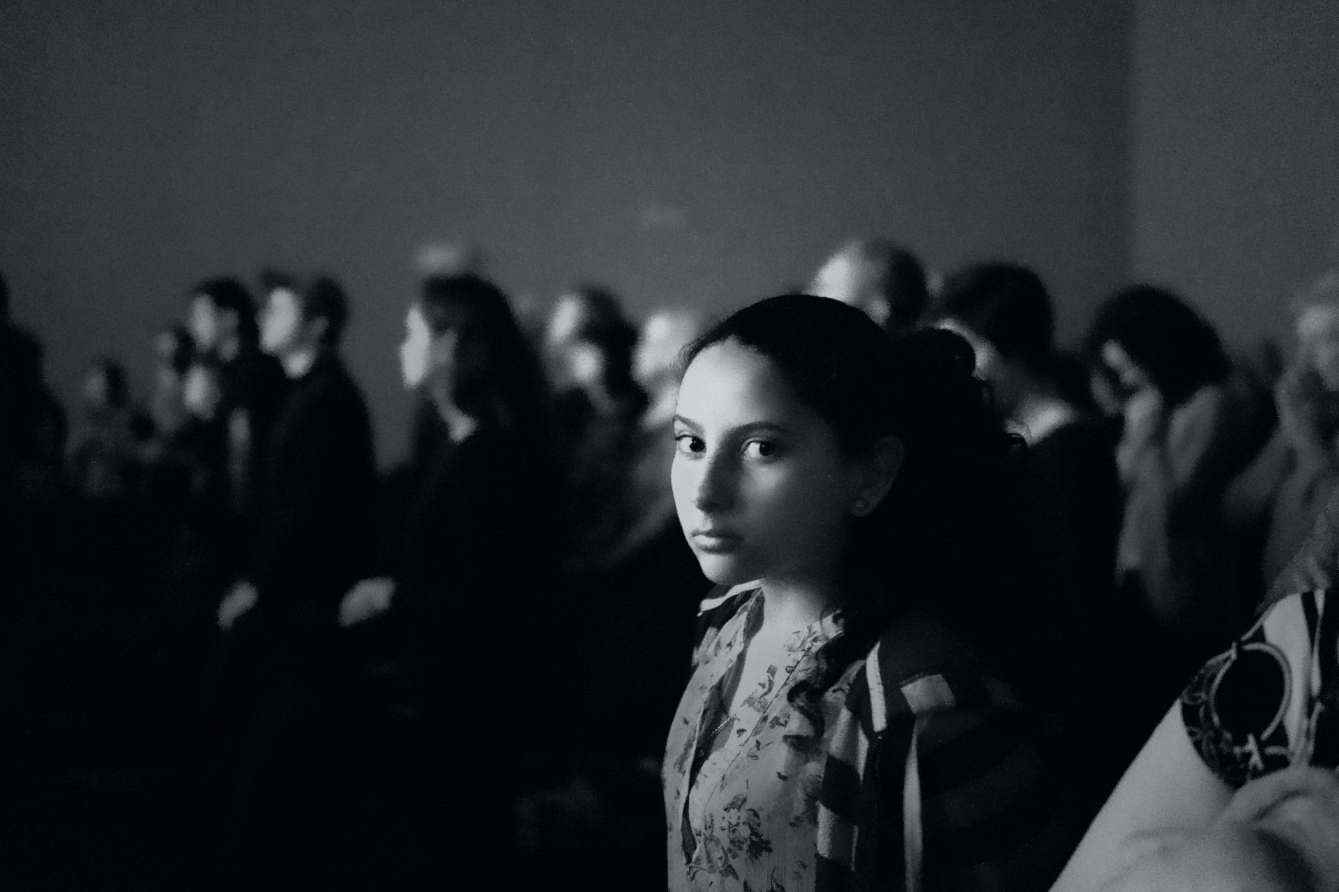 A young woman is looking sideways to the camera