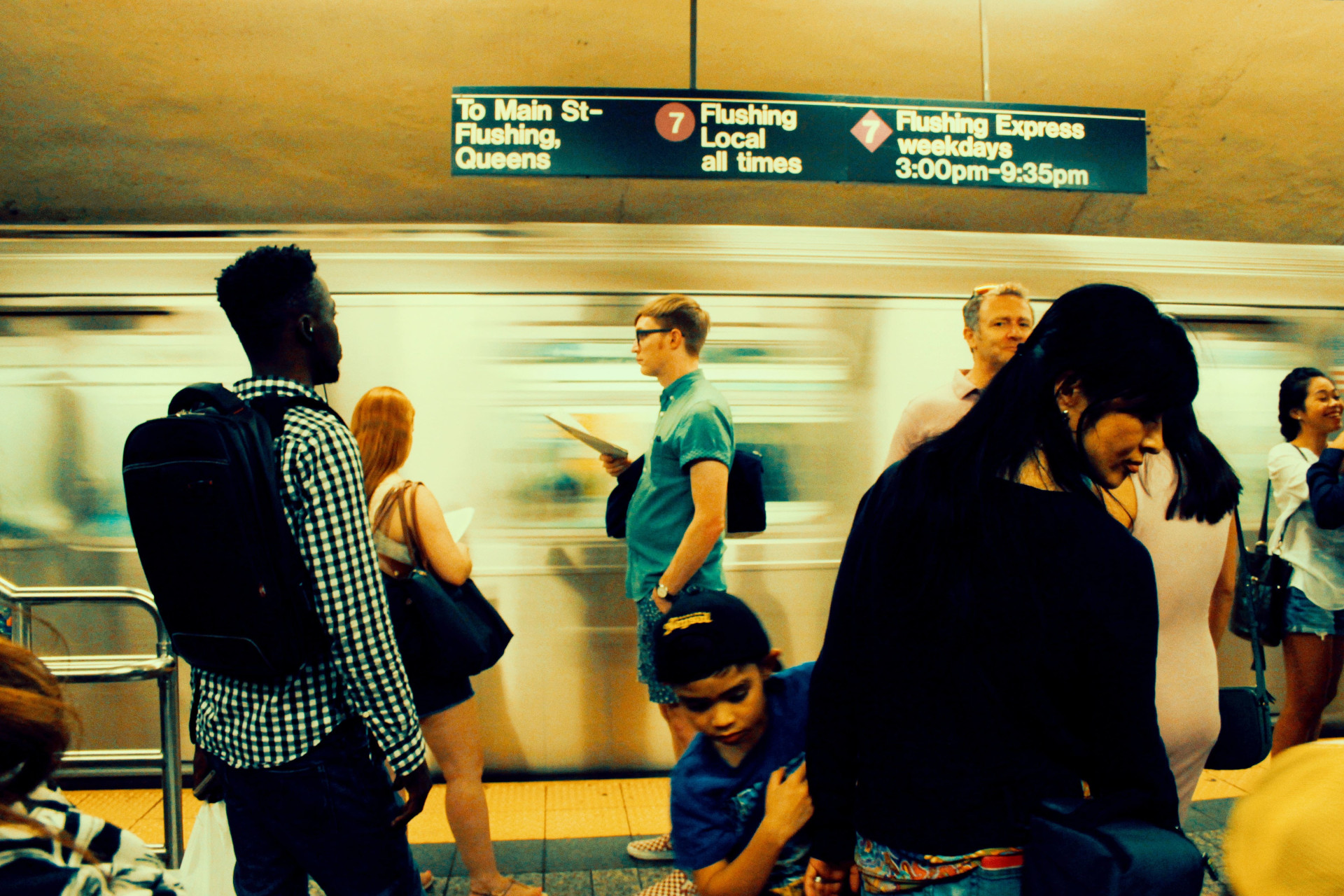 Riders on a platform are waiting for the train