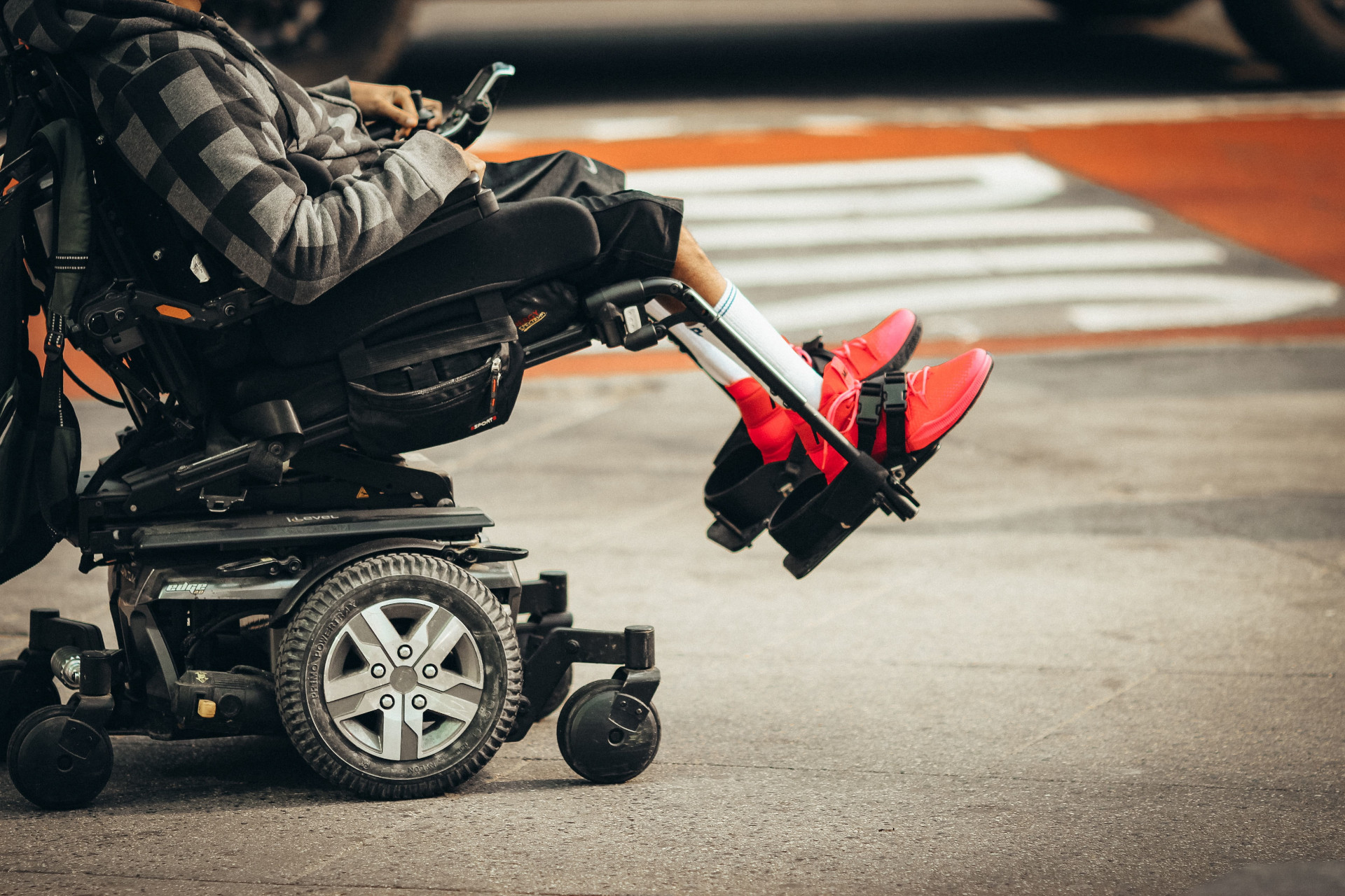A person using an electric wheelchair is getting around in the streets