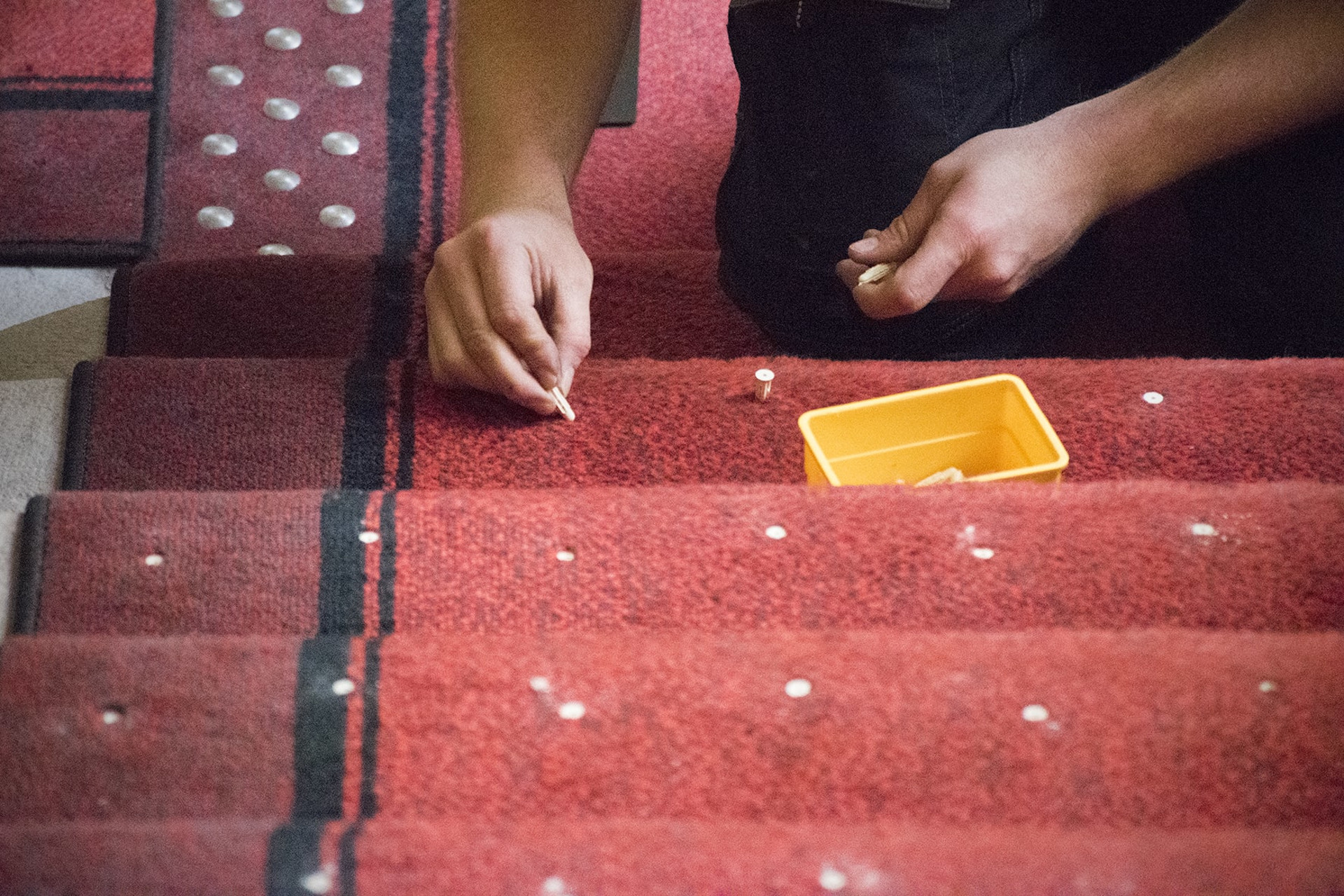 A builder is securing stairs installing contrasting and non-slip stair nosing