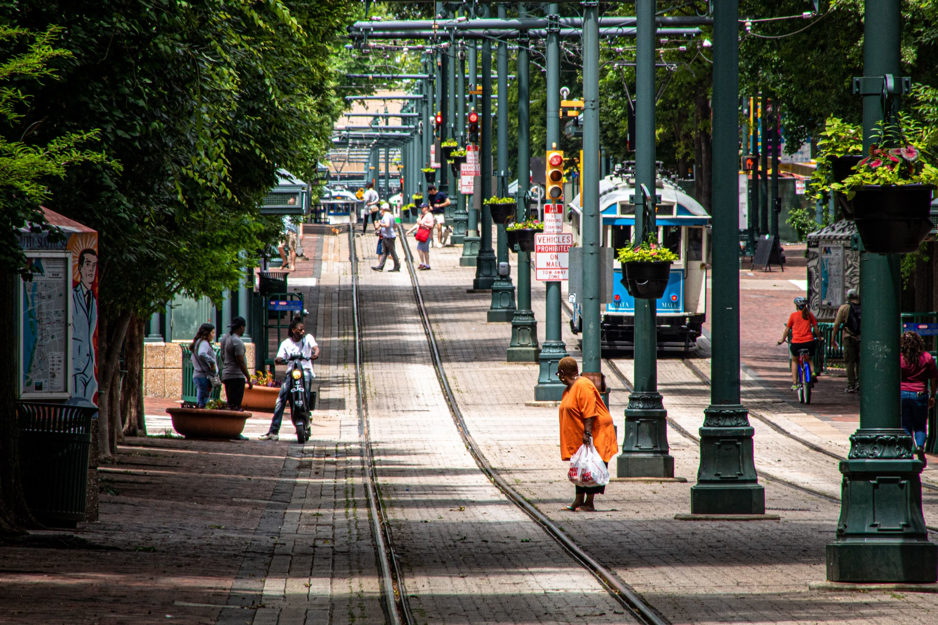 A woman is about to cross the tram rails