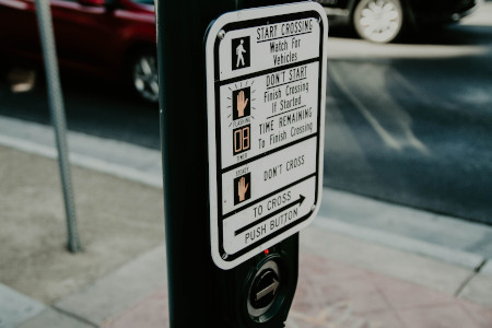 A pushbutton at a crossing with a vibrotactile arrow