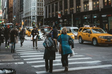 Pedestrians crossing the street in the smart city of New York