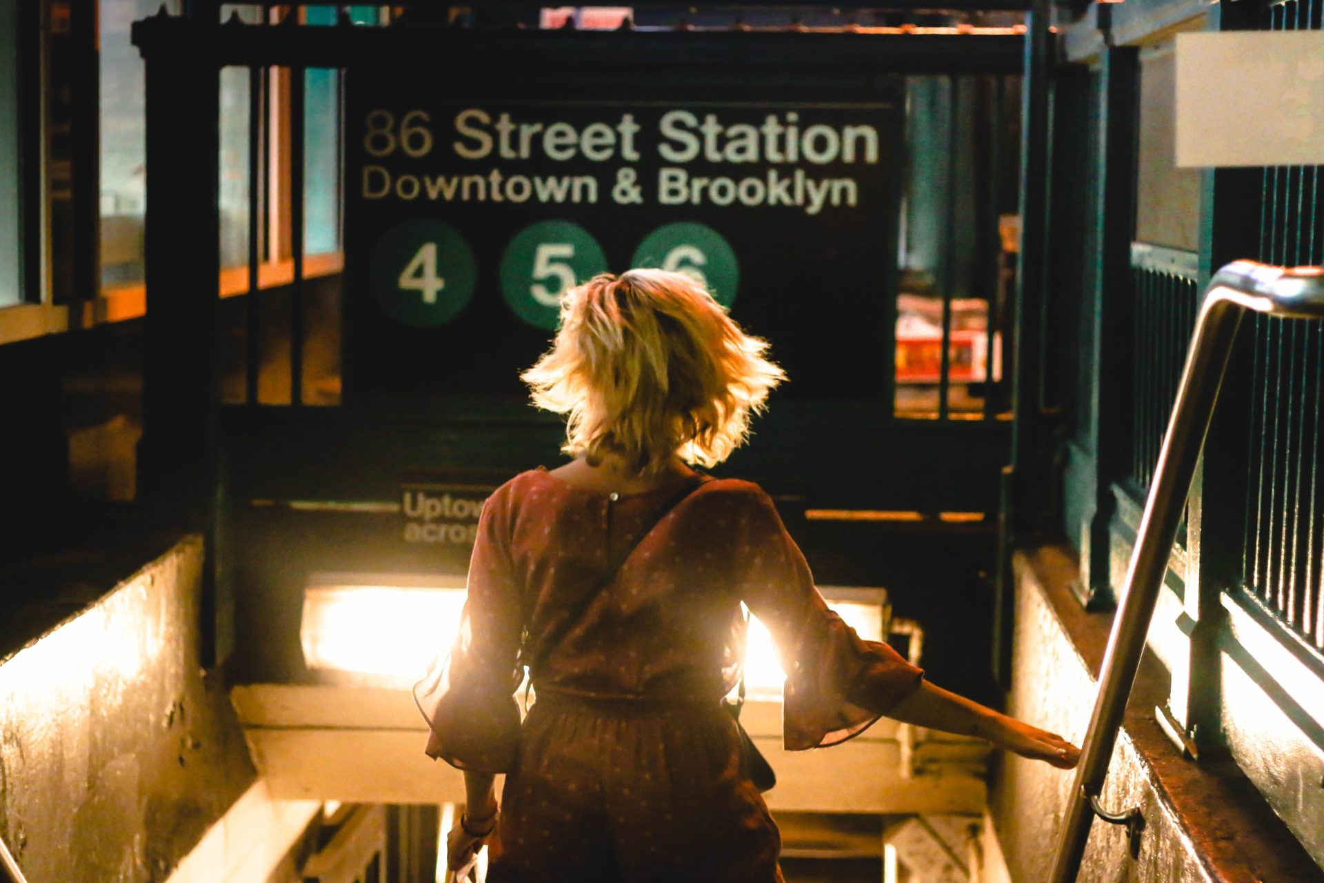 A woman is getting down a subway station in New York City