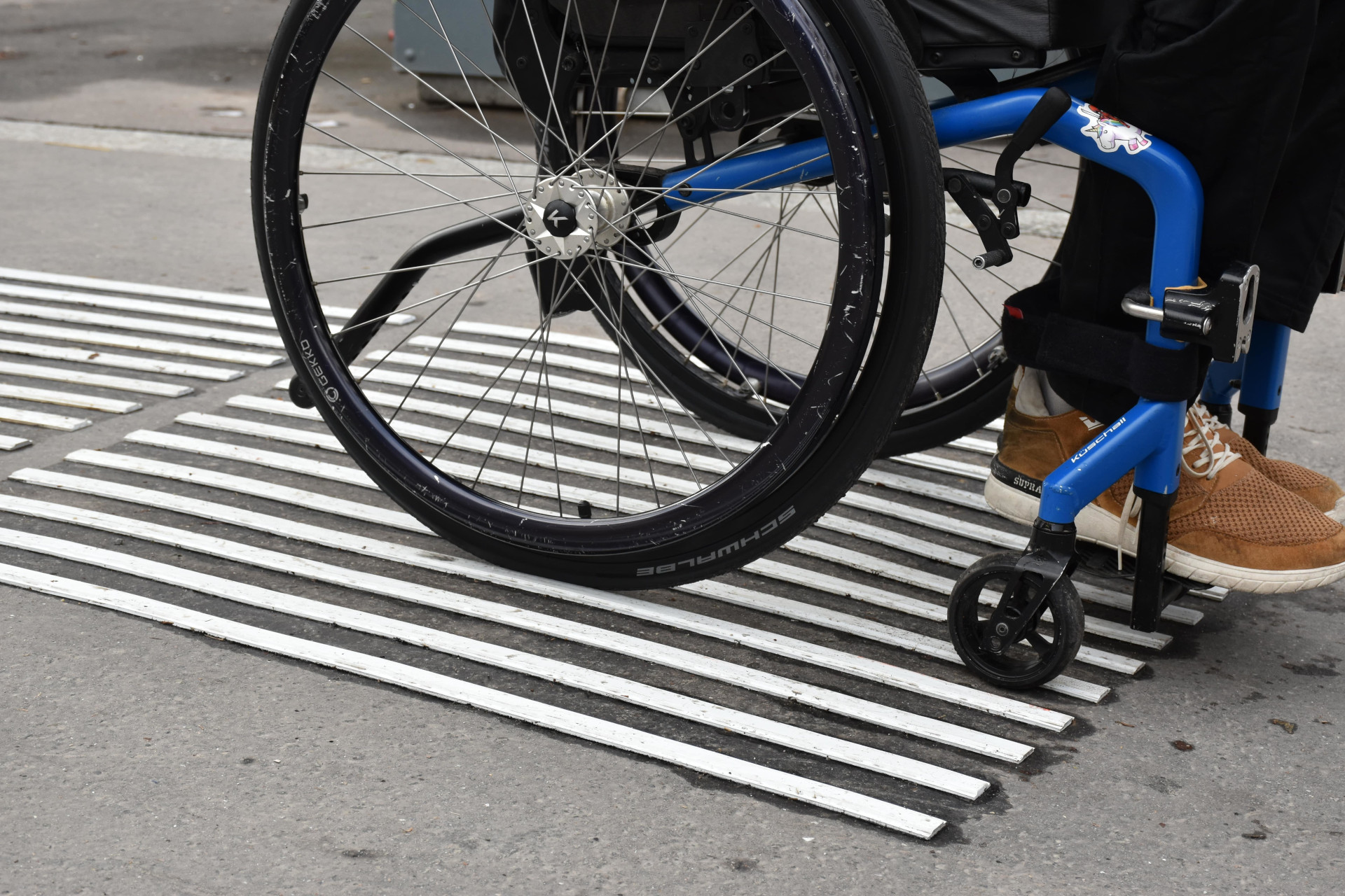 A wheelchair user is testing a tactile paving