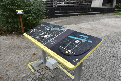 A table set up in the street with multisensory maps